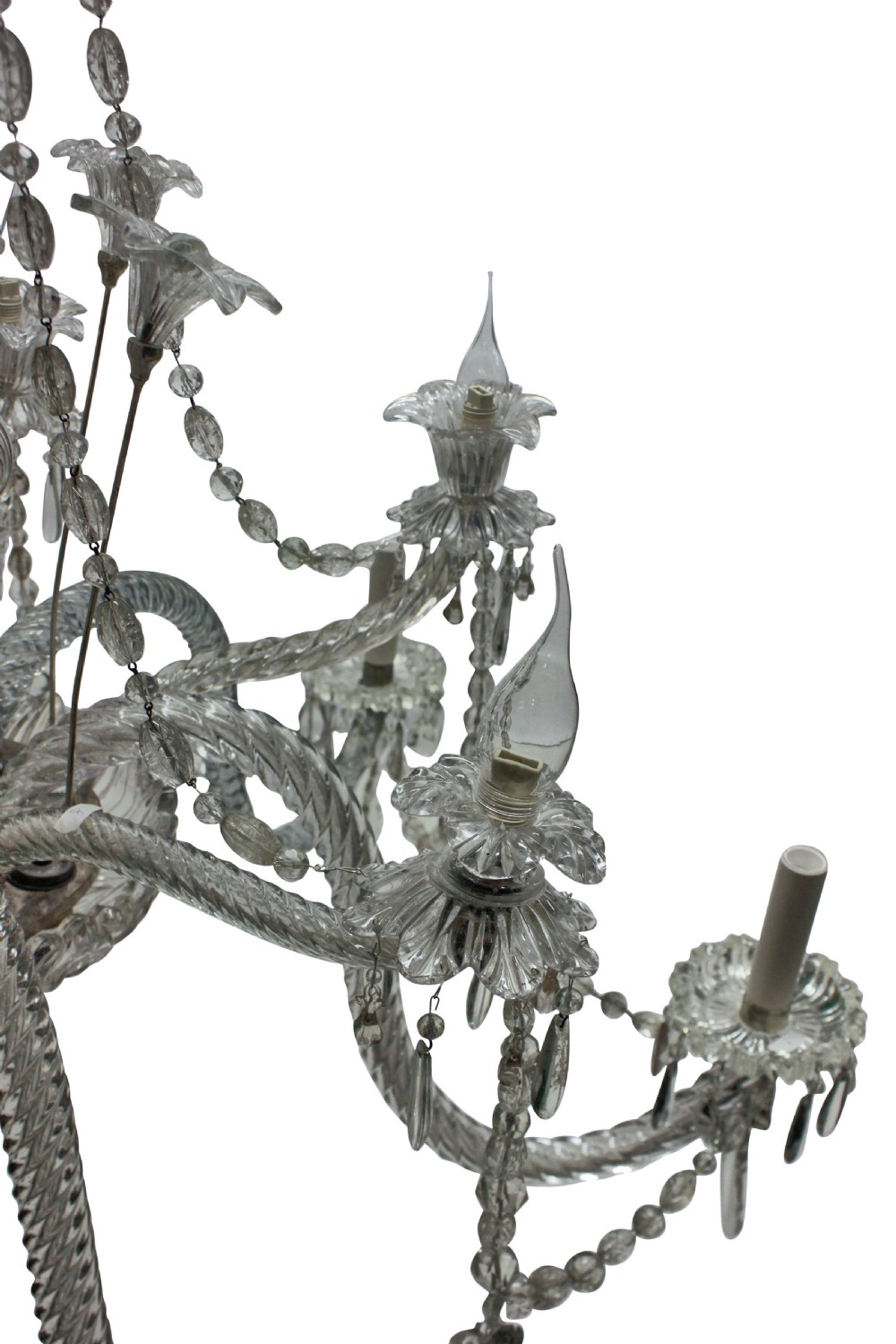 A large French twelve-arm clear cut-crystal chandelier featuring twisted glass arms, cascading crystal drops, and candle-style bulb holders. View V