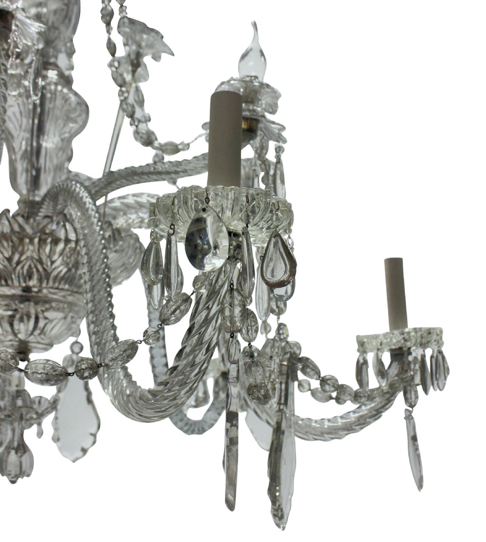 A large French twelve-arm clear cut-crystal chandelier featuring twisted glass arms, cascading crystal drops, and candle-style bulb holders. View VI