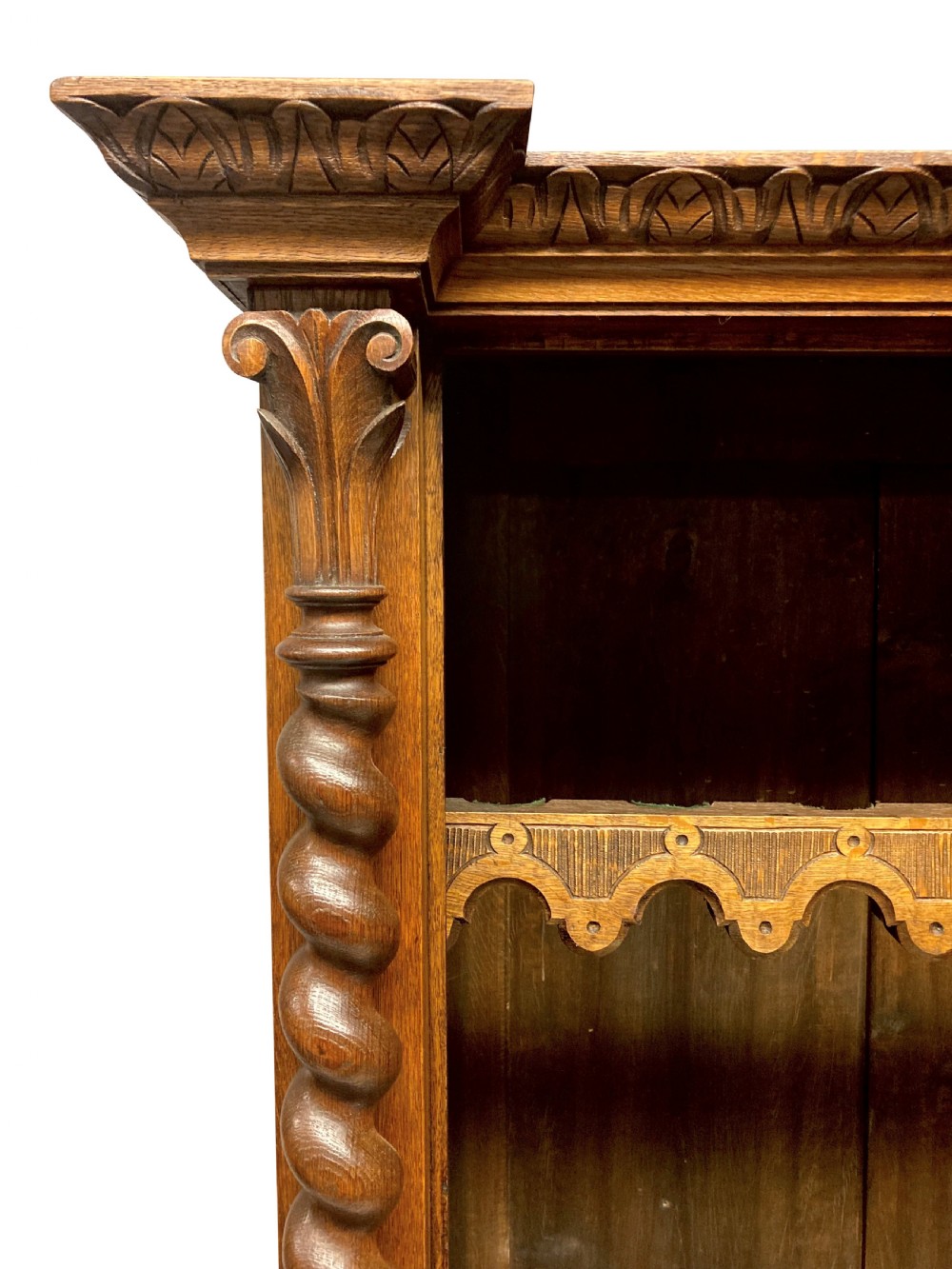 A nineteenth-century carved oak gun cabinet featuring spiralled barley twist columns, a glazed upper door, and relief-carved botanical motifs on the lower door. View VII
