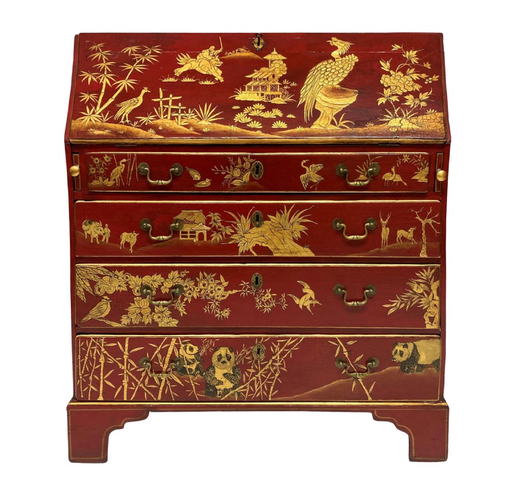 A George III scarlet japanned writing bureau featuring gilded Chinoiserie imagery, a slant front, and four long drawers on bracket feet.
