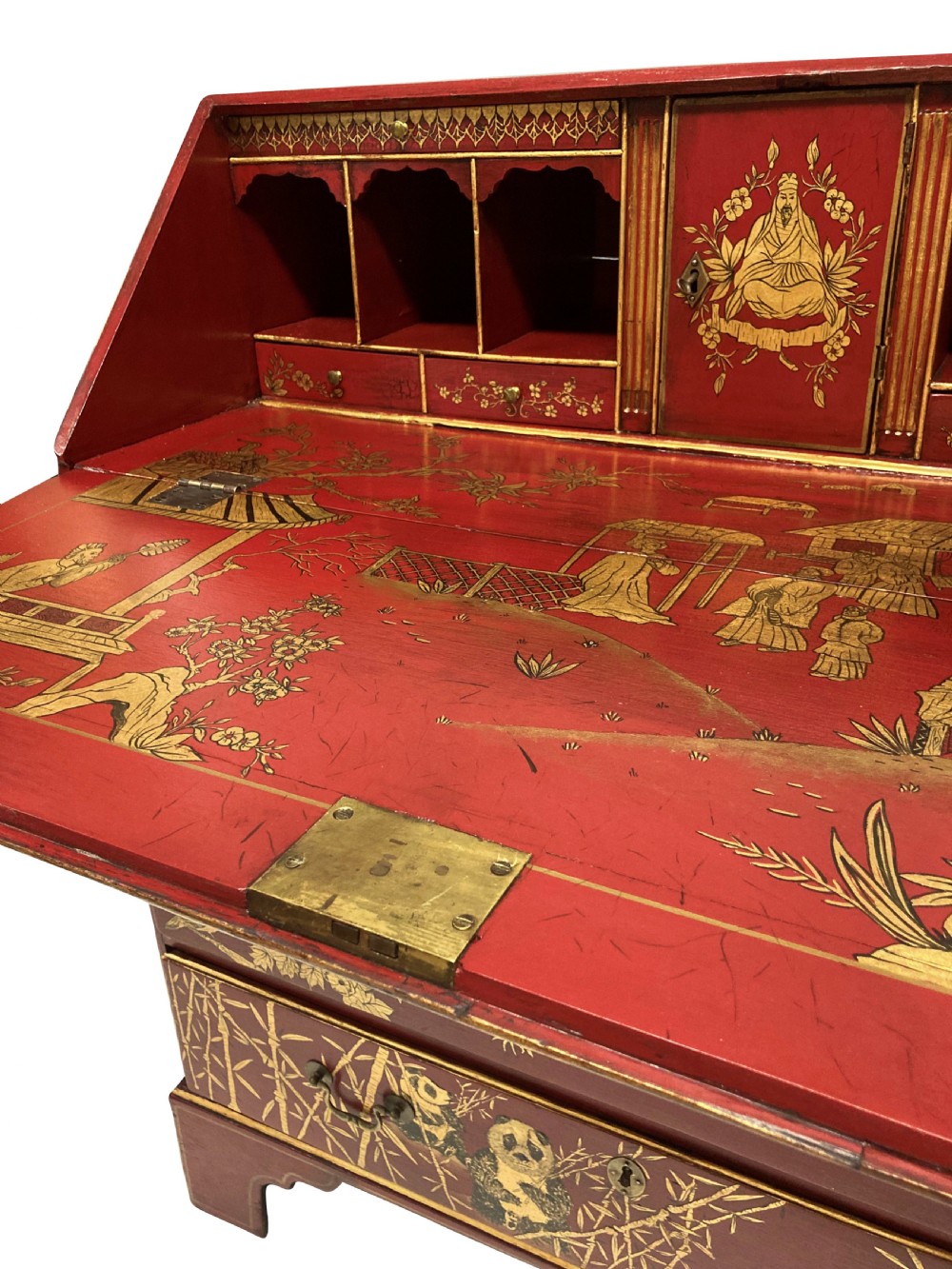 A George III scarlet japanned writing bureau featuring gilded Chinoiserie imagery, a slant front, and four long drawers on bracket feet. View VI