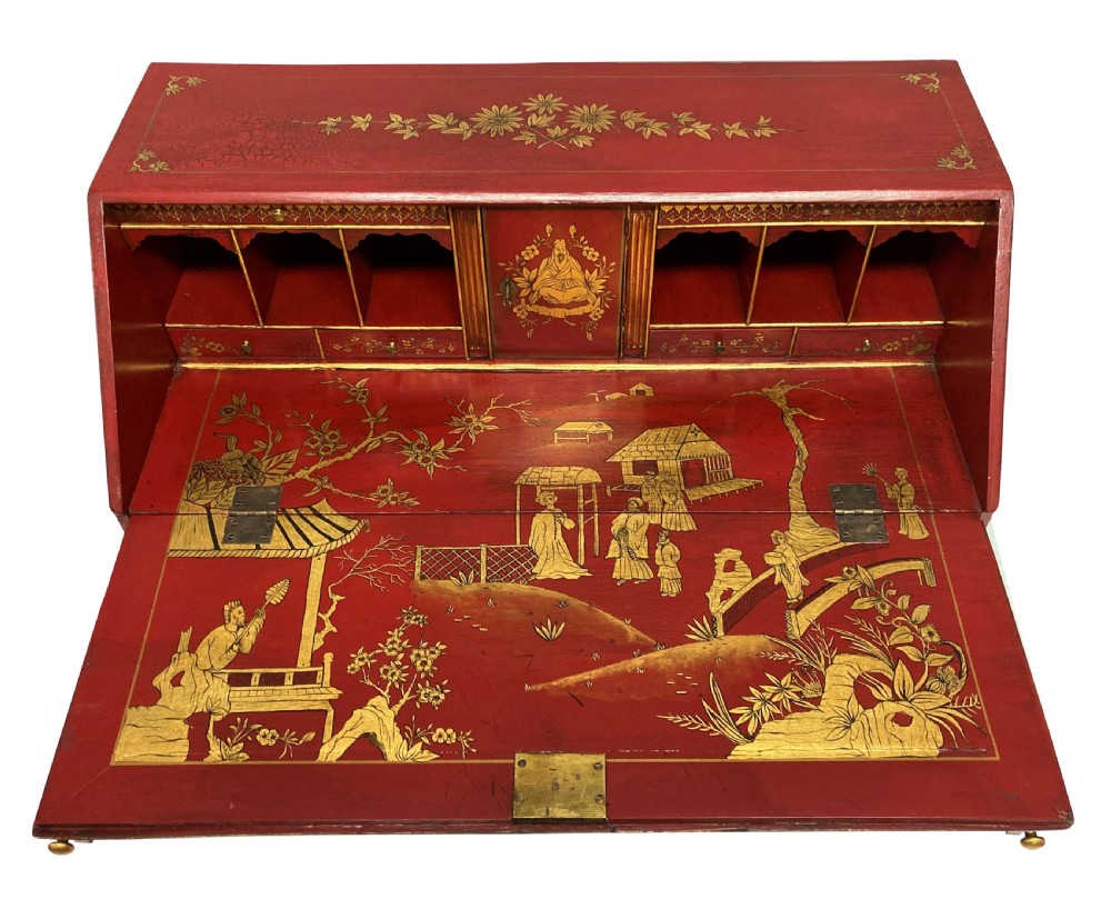 A George III scarlet japanned writing bureau featuring gilded Chinoiserie imagery, a slant front, and four long drawers on bracket feet. View VII