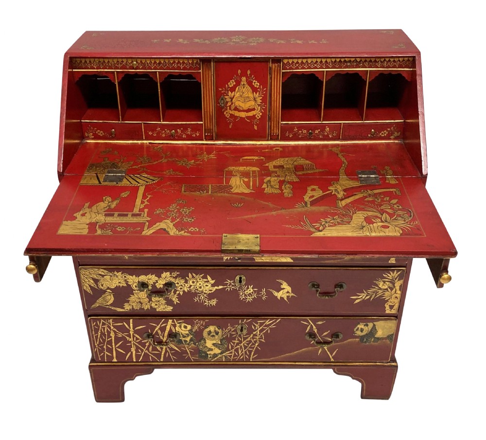 A George III scarlet japanned writing bureau featuring gilded Chinoiserie imagery, a slant front, and four long drawers on bracket feet. View XII