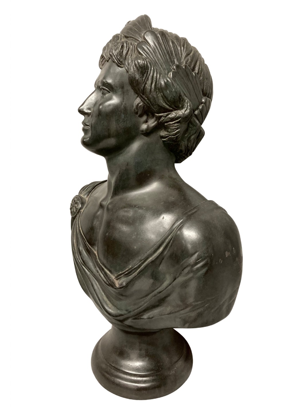 A dark bronzed plaster library bust depicting the Emperor Augustus draped in Roman robes and mounted on a rounded socle base. View II