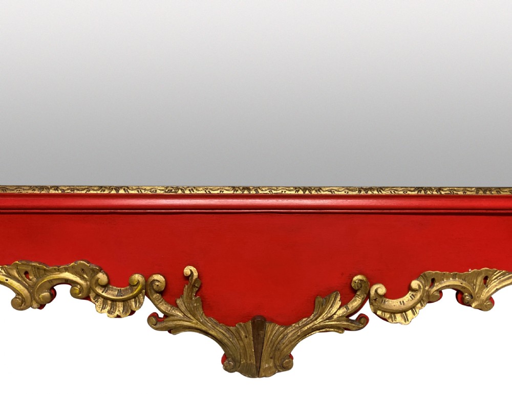 A George II style horizontal wall mirror featuring a scarlet red lacquered frame adorned with intricate giltwood rococo scrollwork and a central eagle crest. View IV