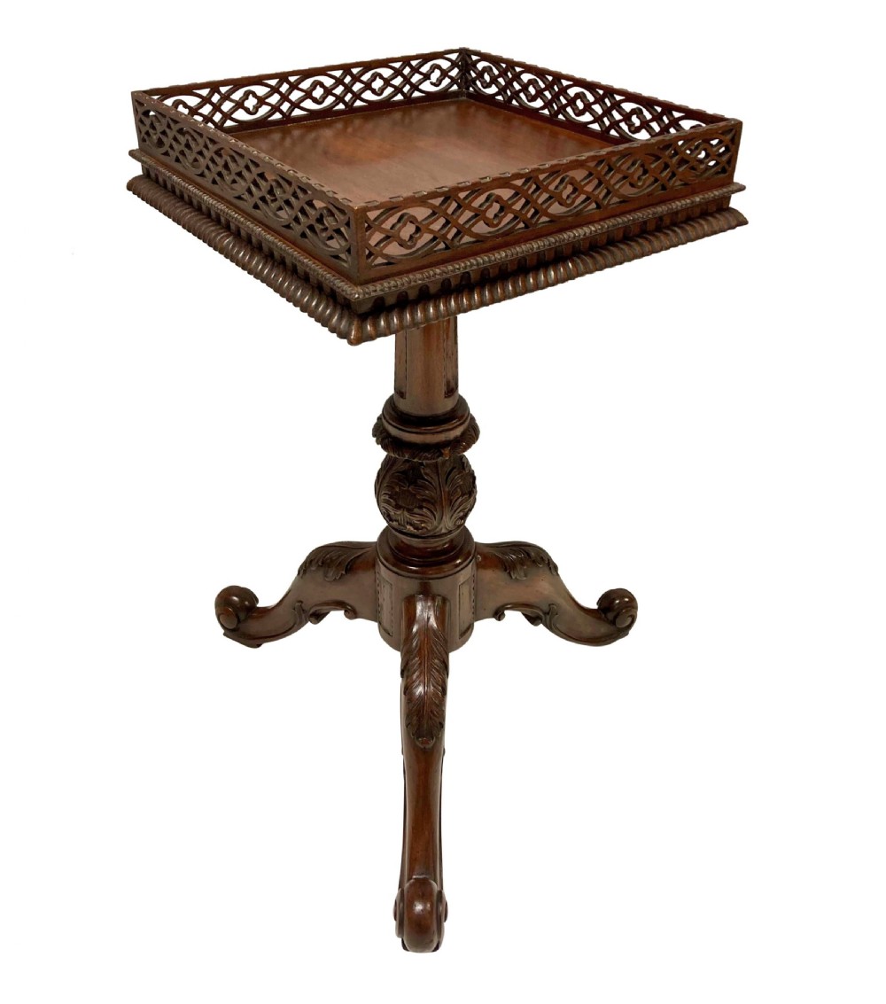 A pair of mahogany wine tables with square pierced fretwork galleries, carved central pedestals, and carved tripod cabriole legs. View II