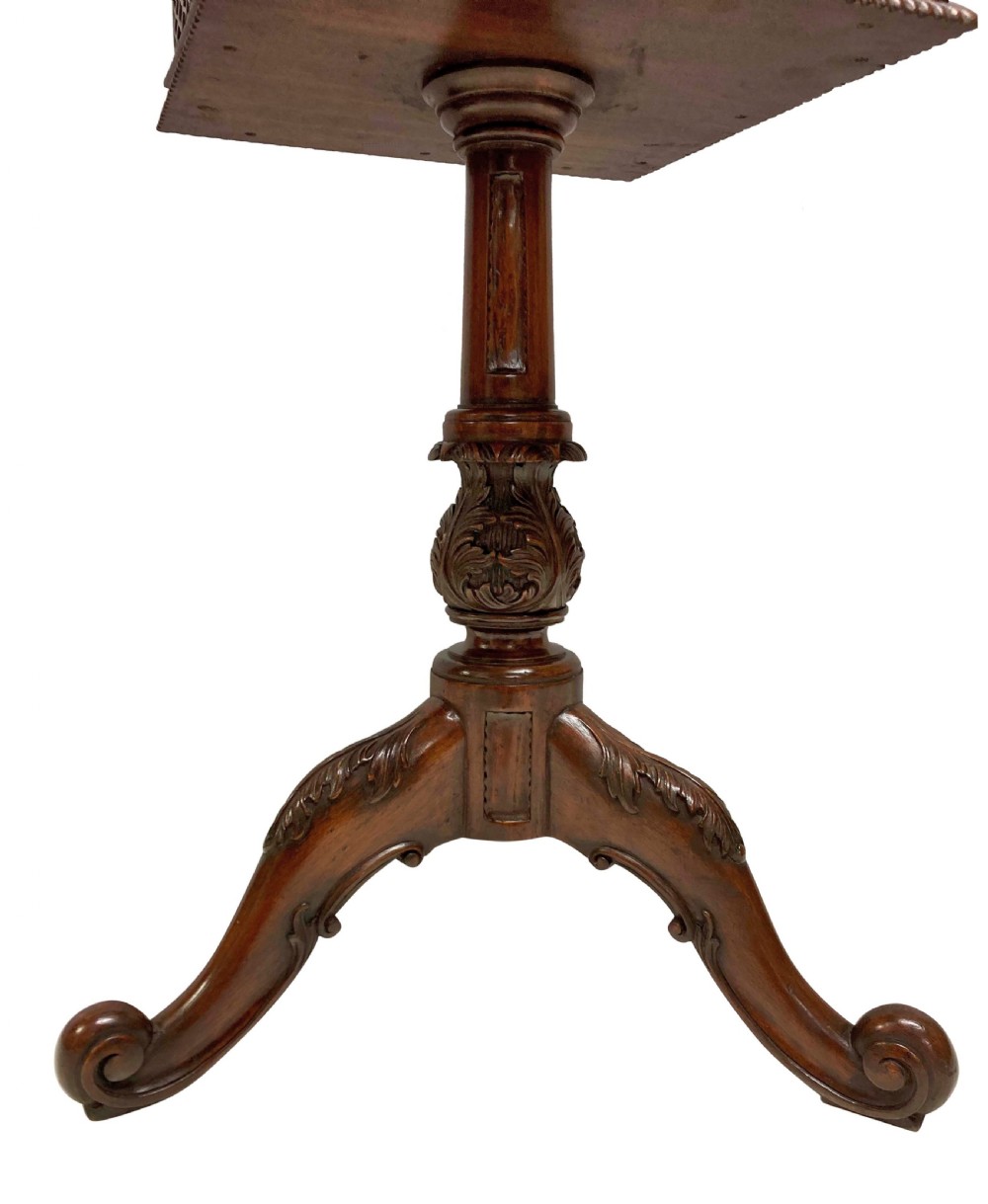 A pair of mahogany wine tables with square pierced fretwork galleries, carved central pedestals, and carved tripod cabriole legs. View VI