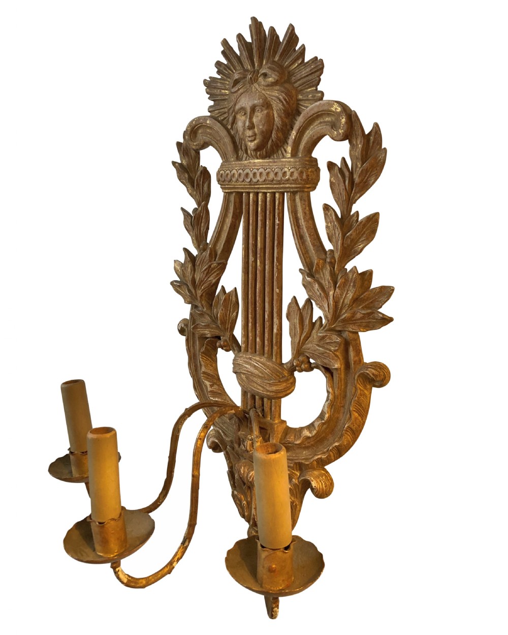 A pair of carved French giltwood wall sconces crafted in the shape of a musical lyre, featuring an Apollo sunburst mask top and three scrolling candle branches. View III