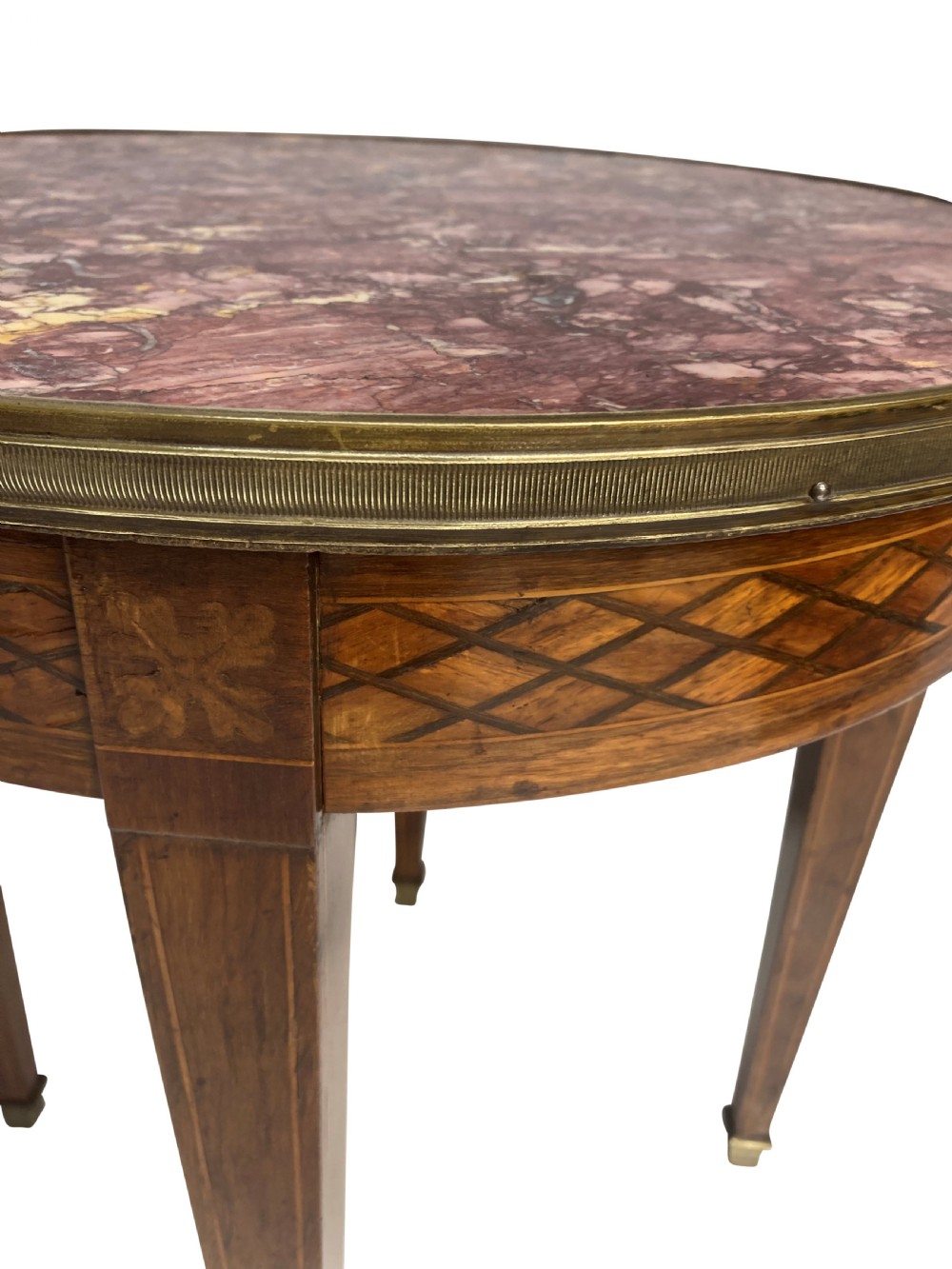 A nineteenth-century French circular gueridon table with a mottled marble top, brass rim, diamond parquetry frieze, and tapered legs. View II