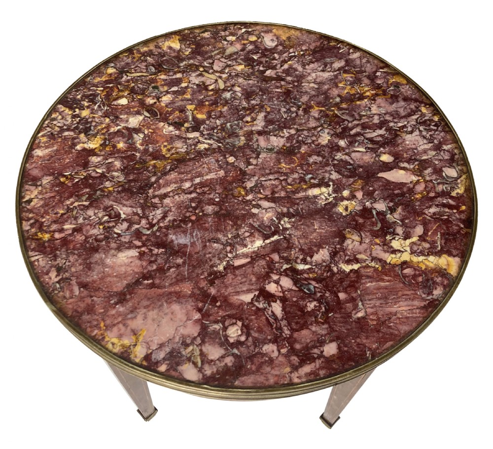 A nineteenth-century French circular gueridon table with a mottled marble top, brass rim, diamond parquetry frieze, and tapered legs. View III