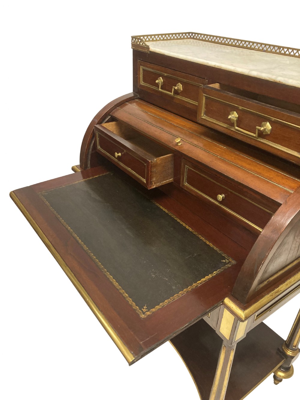 A small Directoire style mahogany cylinder desk with brass inlay trim, a marble top framed by a pierced brass gallery, slatted roll-top cylinder, drawer, and tapered legs. View III