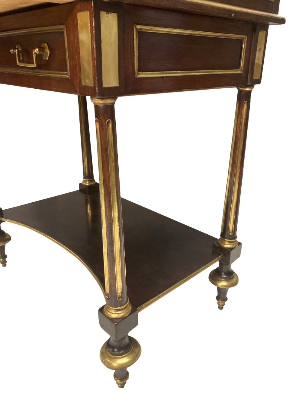 A small Directoire style mahogany cylinder desk with brass inlay trim, a marble top framed by a pierced brass gallery, slatted roll-top cylinder, drawer, and tapered legs. View VIII