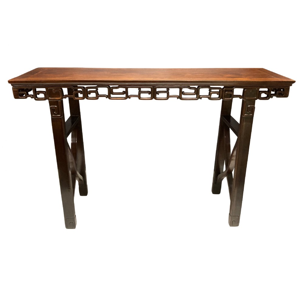 A dark brown Chinese Qing dynasty console table featuring an openwork geometric fretwork apron and curved side stretchers. View II