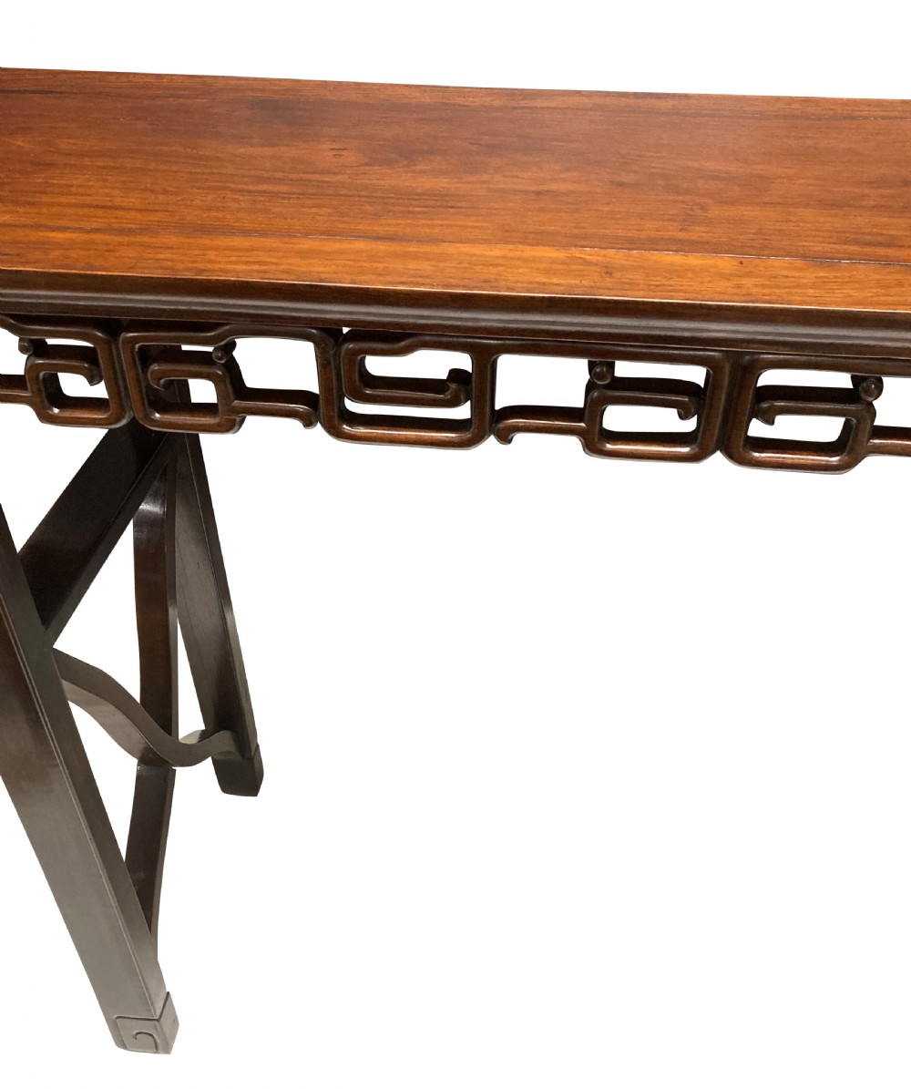 A dark brown Chinese Qing dynasty console table featuring an openwork geometric fretwork apron and curved side stretchers. View III