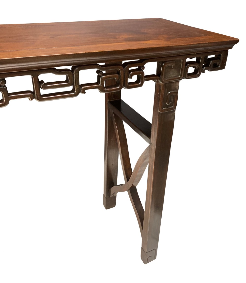 A dark brown Chinese Qing dynasty console table featuring an openwork geometric fretwork apron and curved side stretchers. View VI