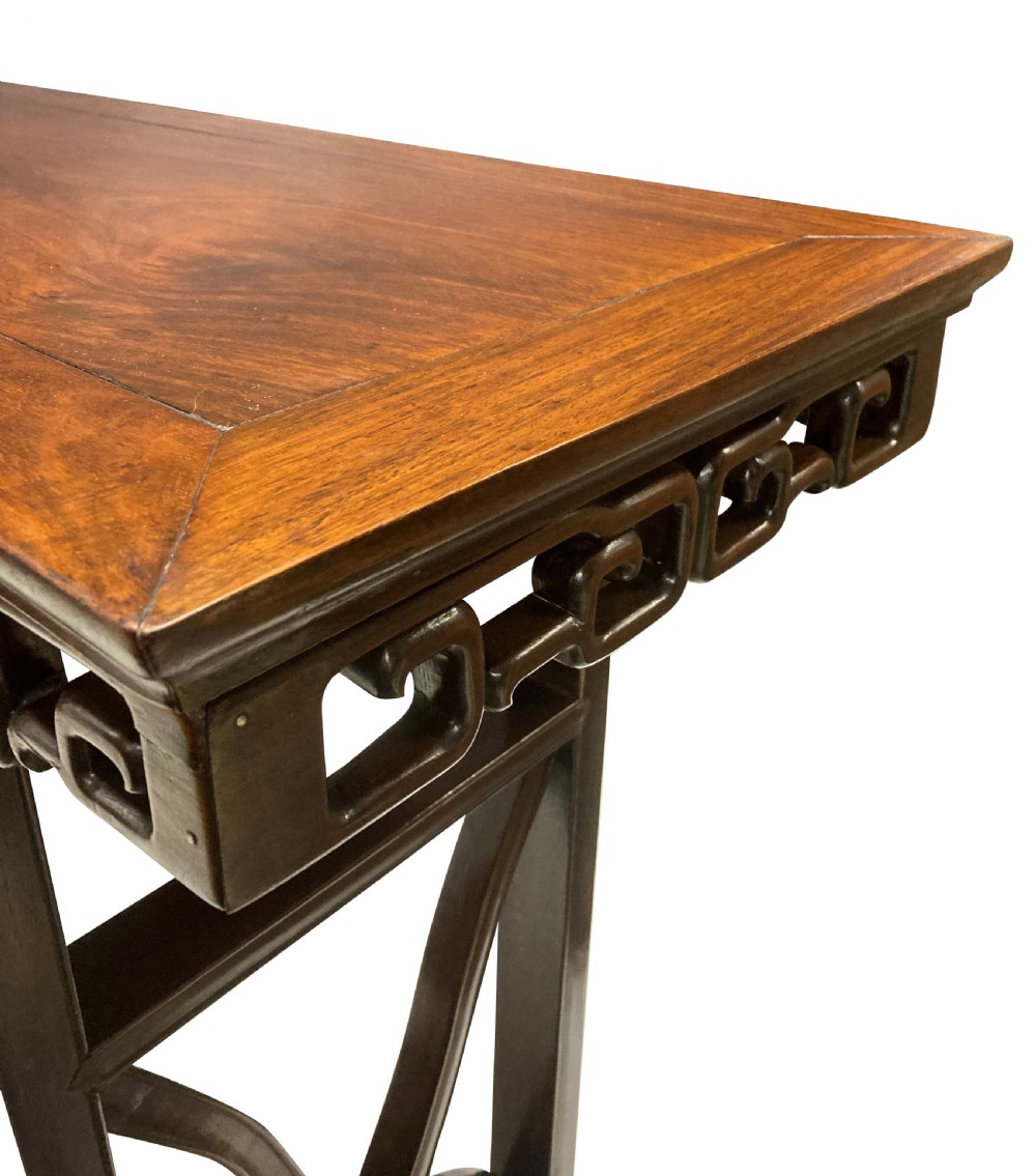 A dark brown Chinese Qing dynasty console table featuring an openwork geometric fretwork apron and curved side stretchers. View VIII