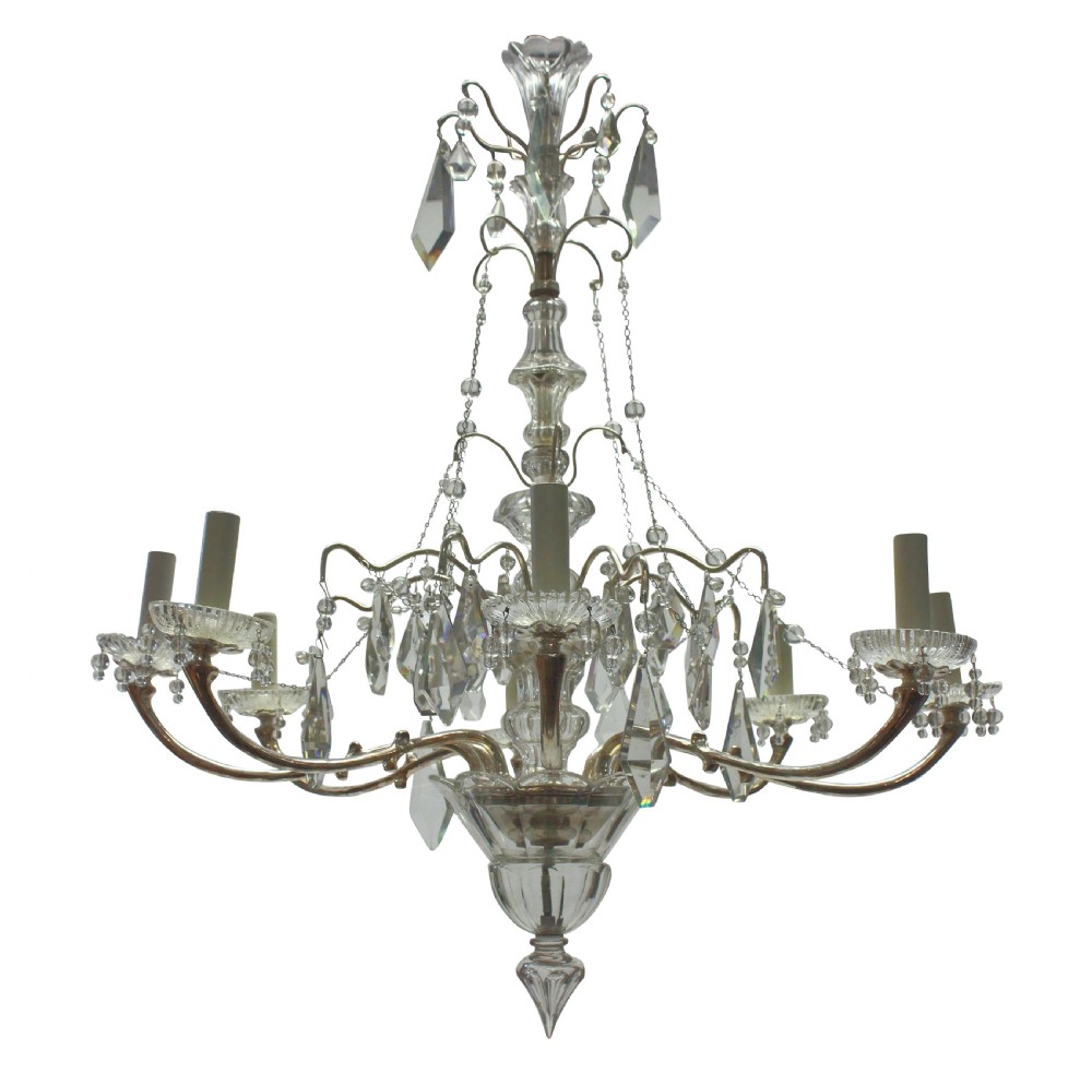 A multi-arm cut glass chandelier featuring clear crystal drop pendants, drip pans, and silvered metal framework with candle-style lamp sockets.