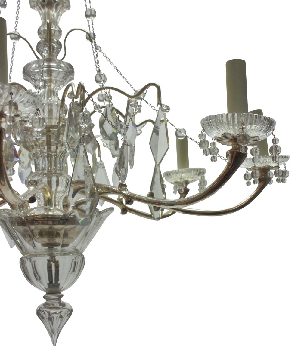 A multi-arm cut glass chandelier featuring clear crystal drop pendants, drip pans, and silvered metal framework with candle-style lamp sockets. View II