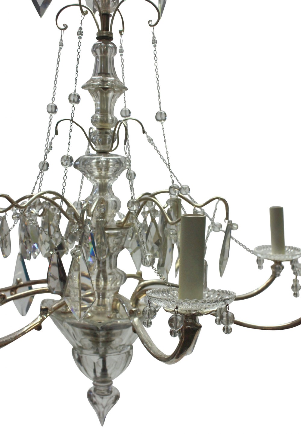 A multi-arm cut glass chandelier featuring clear crystal drop pendants, drip pans, and silvered metal framework with candle-style lamp sockets. View V