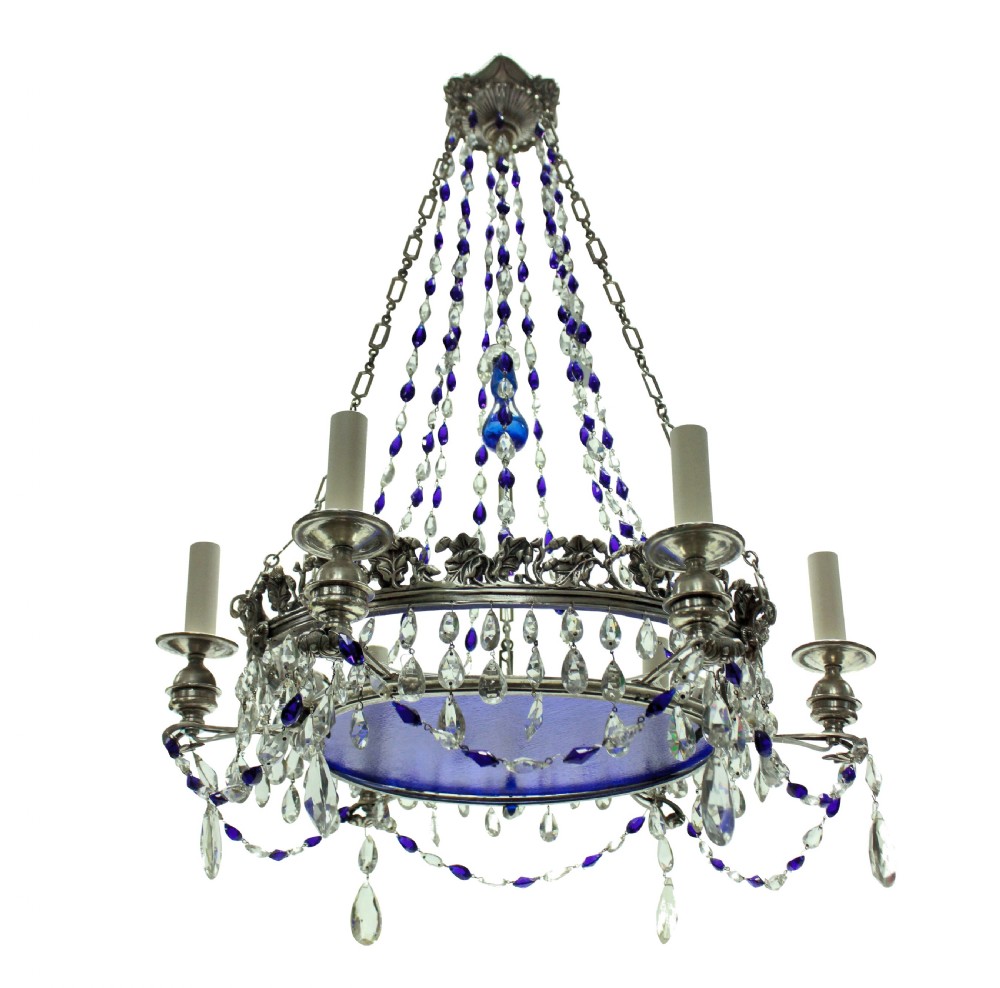 A 19th-century silver-plated circular chandelier featuring clear and cobalt blue cut glass drops, candle sleeves, and a central cobalt glass insert suspended by chains.