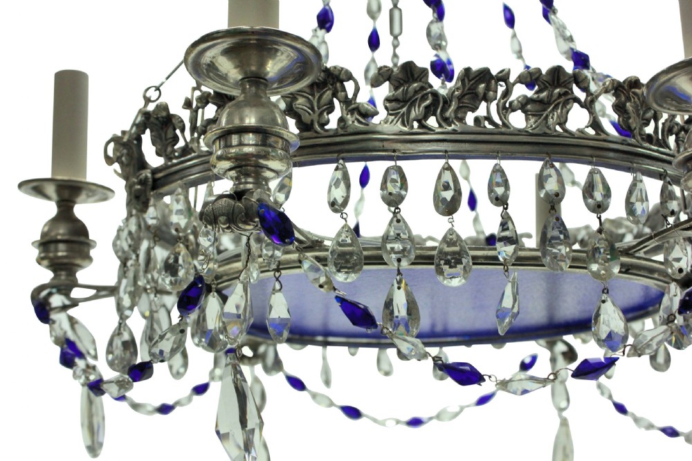 A 19th-century silver-plated circular chandelier featuring clear and cobalt blue cut glass drops, candle sleeves, and a central cobalt glass insert suspended by chains. View V