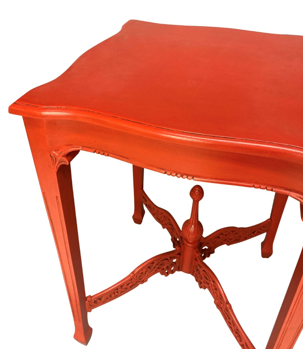 A pair of scarlet red square side tables featuring serpentine tops, carved corner brackets, and intricate pierced X-stretchers with central finials. View V