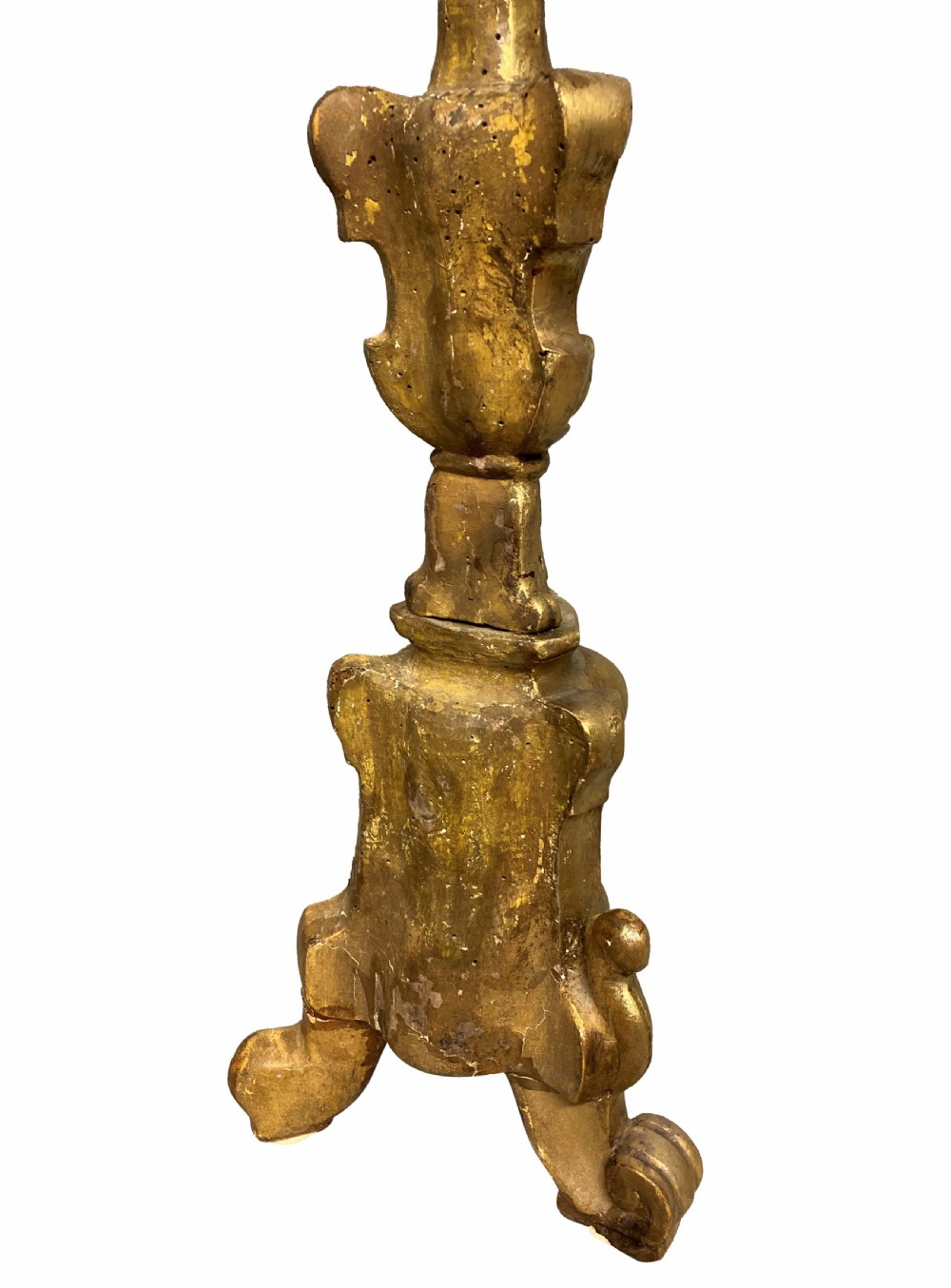 A pair of tall 18th-century Italian carved giltwood table lamps featuring scroll bases, shell carvings, and cream faux candle stems. View IV
