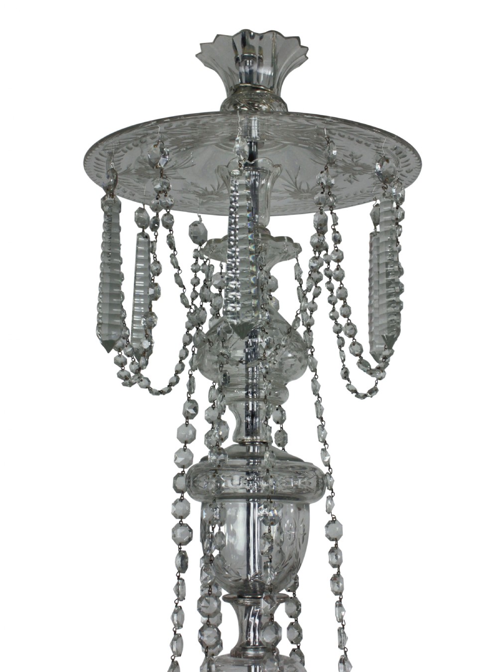A nineteenth-century English cut glass chandelier featuring twelve candle-style lights, glass swags, hung faceted droplets, and a central baluster stem. View IV