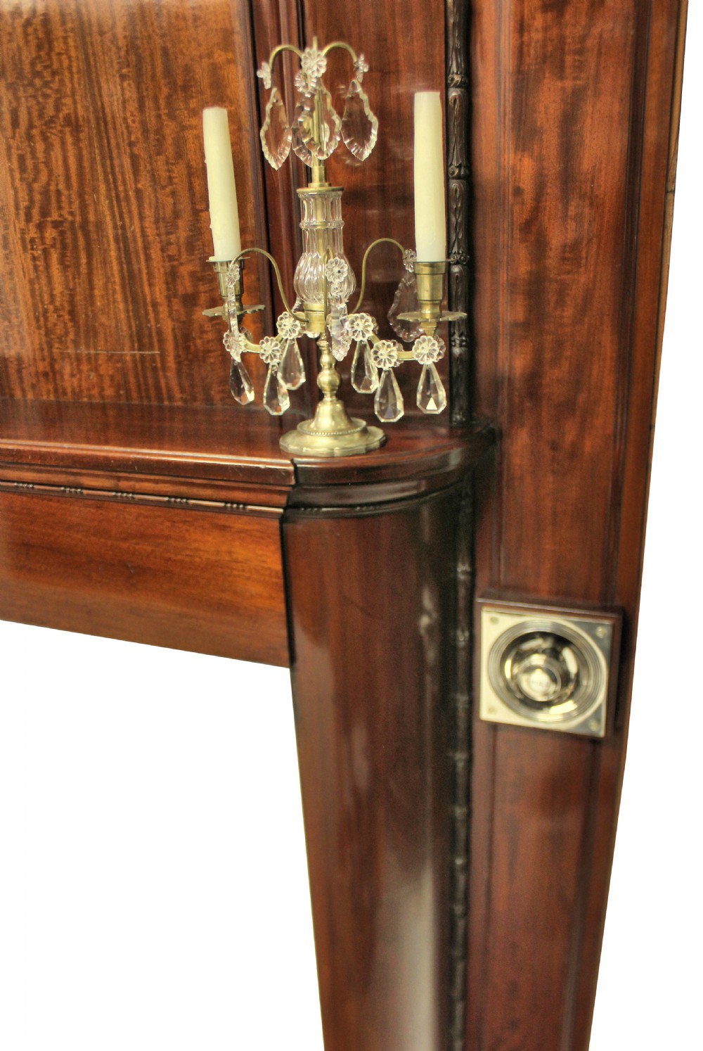 A large dark polished mahogany chimneypiece featuring an integrated panelled overmantel and architectural stepped mouldings. View X