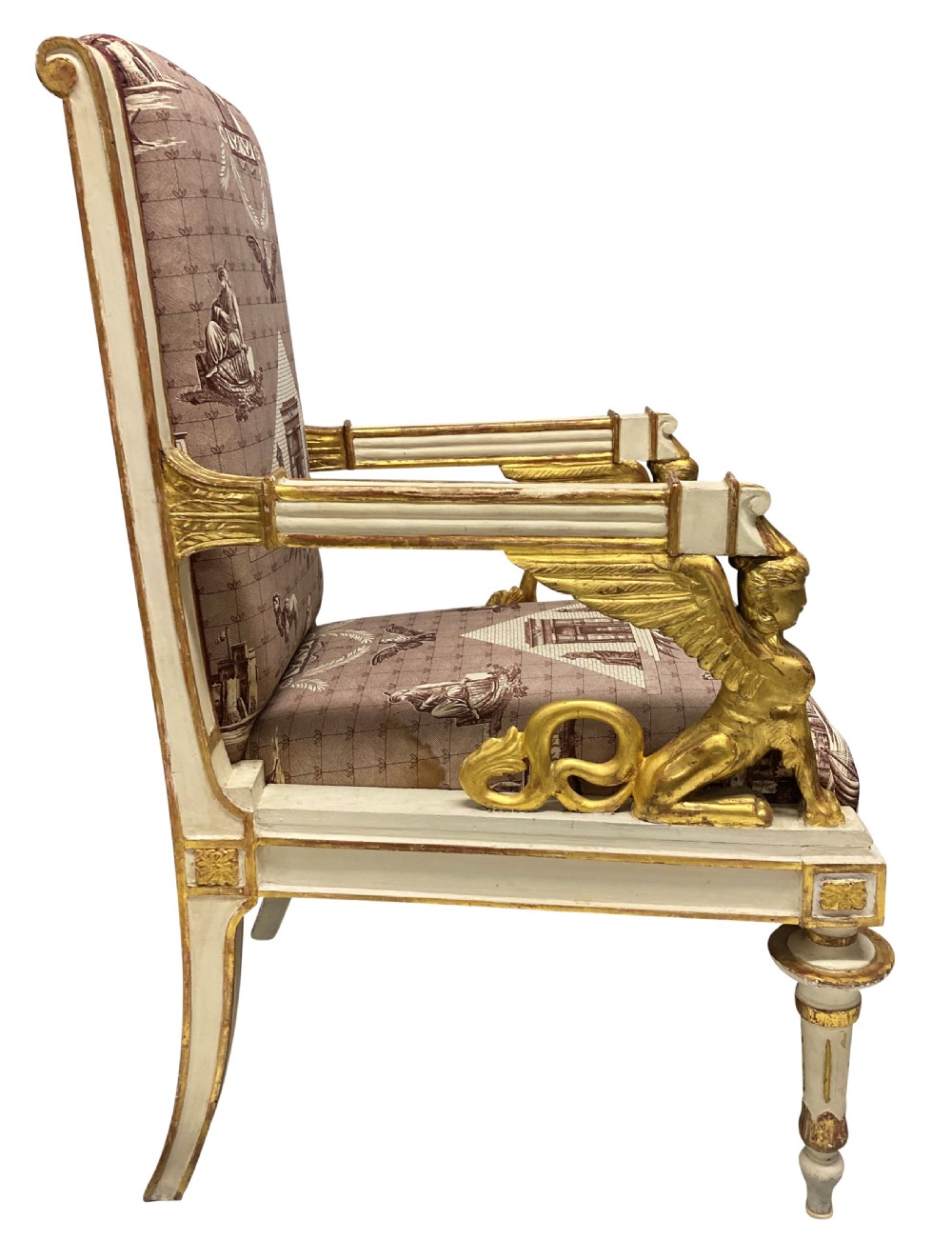 A French Empire armchair featuring a white painted frame with gilt sphinx arm supports and Egyptian revival fabric upholstery. View II