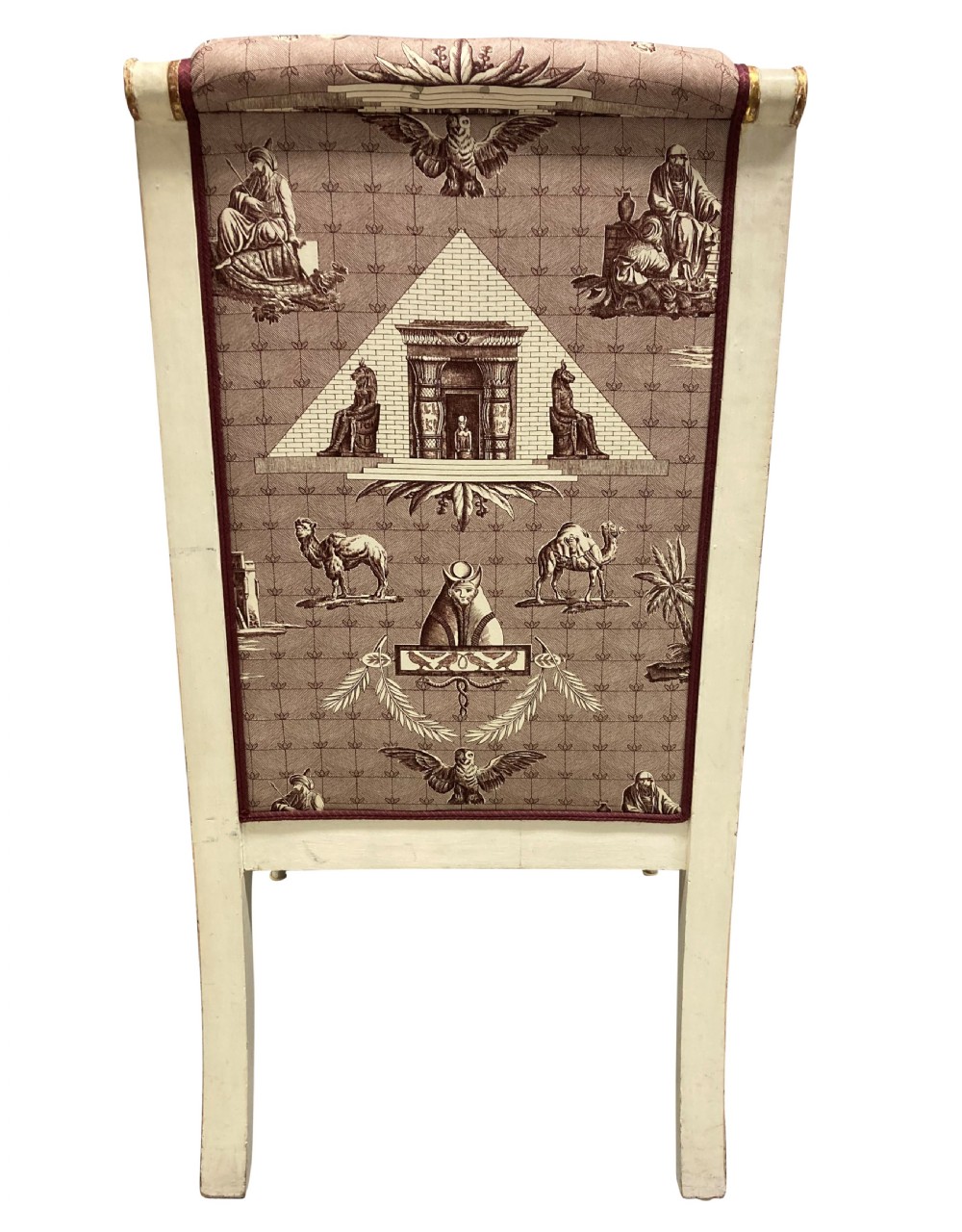 A French Empire armchair featuring a white painted frame with gilt sphinx arm supports and Egyptian revival fabric upholstery. View IV