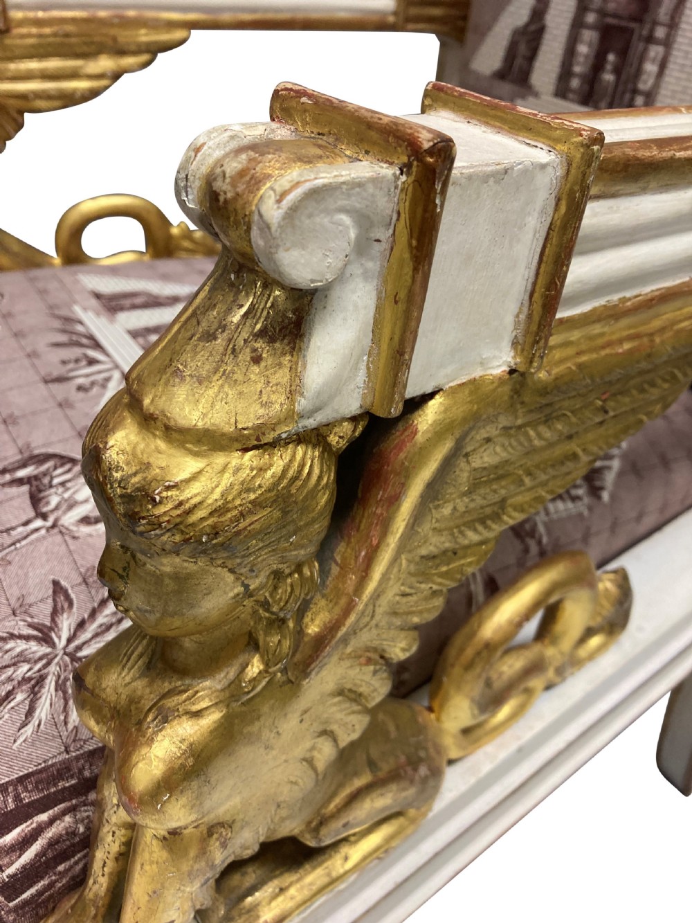 A French Empire armchair featuring a white painted frame with gilt sphinx arm supports and Egyptian revival fabric upholstery. View VI