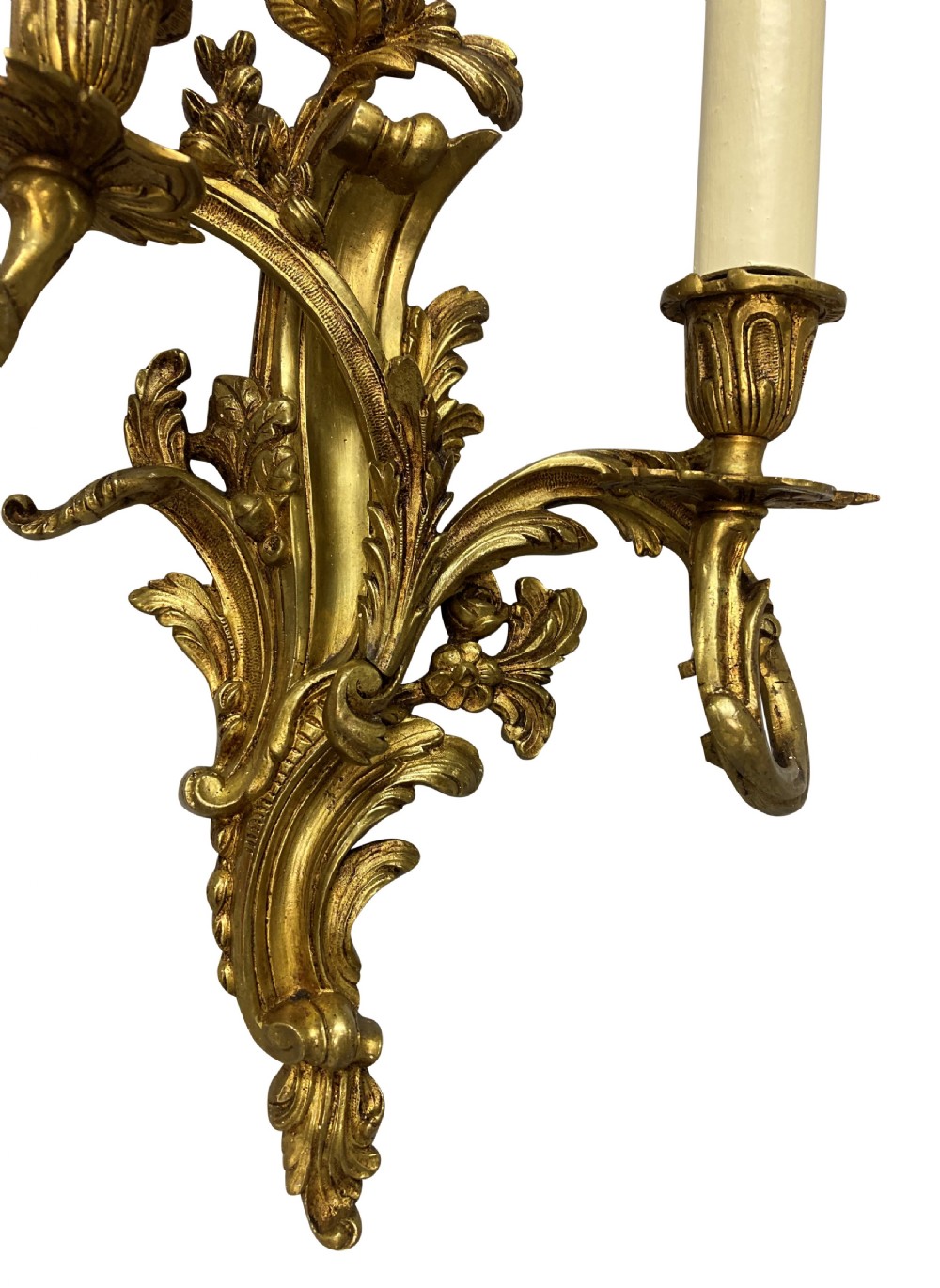 A pair of French Louis XV style gilt bronze two-light wall sconces featuring ornate asymmetrical acanthus foliage and candle holders. View III