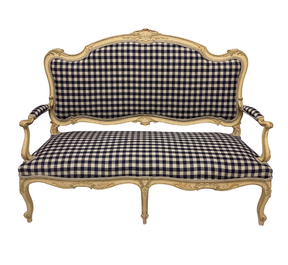 A painted Louis XV style upholstered canape with curved cabriole legs and a navy and cream gingham patterned fabric.