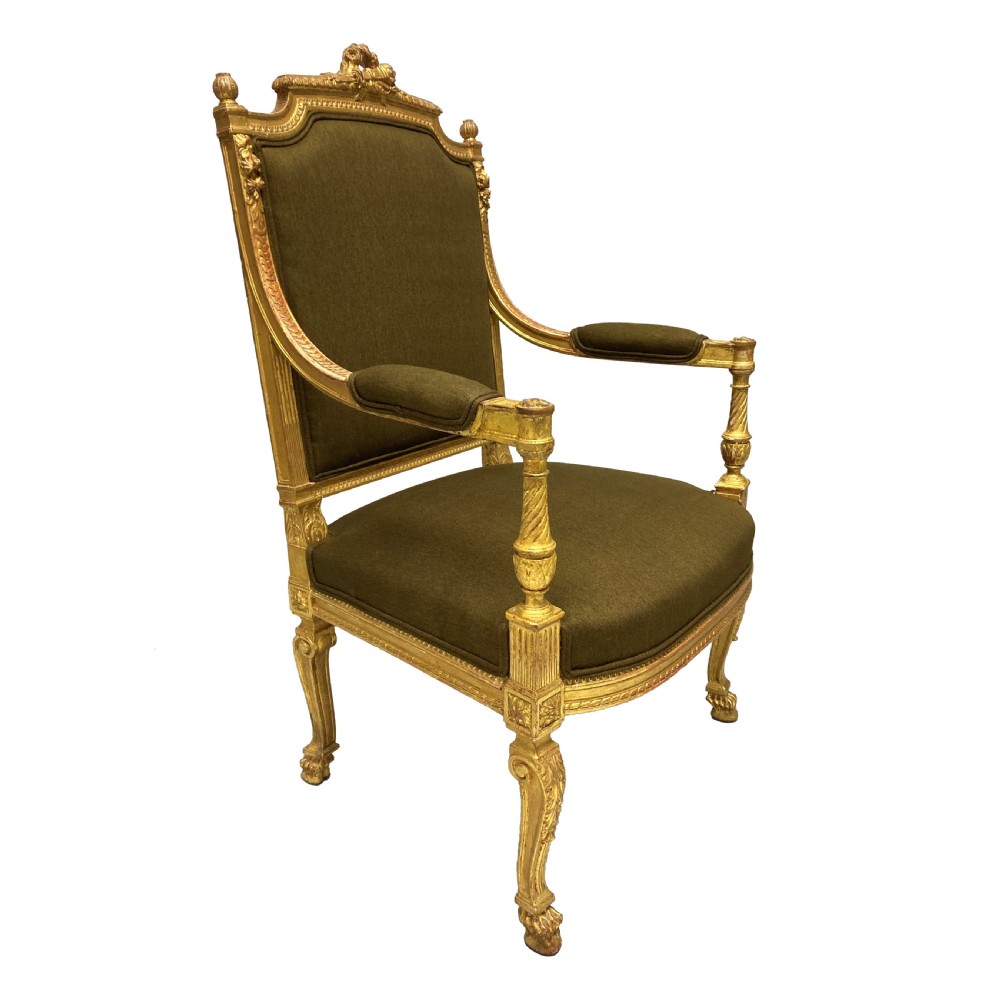 A Louis XIV style giltwood armchair featuring a gold leaf carved frame, turned arm supports, and dark olive green fabric upholstery. View II