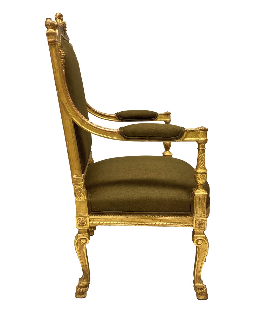 A Louis XIV style giltwood armchair featuring a gold leaf carved frame, turned arm supports, and dark olive green fabric upholstery. View V