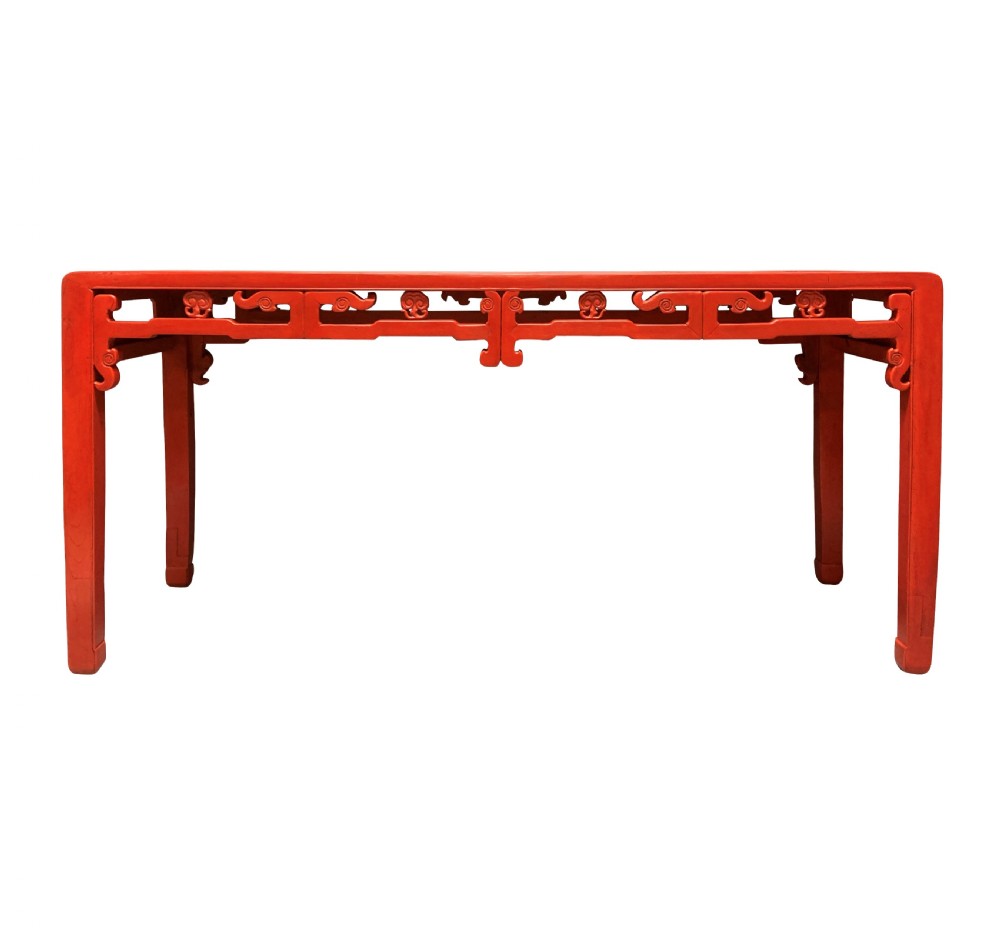 A 19th-century Chinese red lacquered console table featuring a long rectangular top and carved scroll aprons along the frame. View II