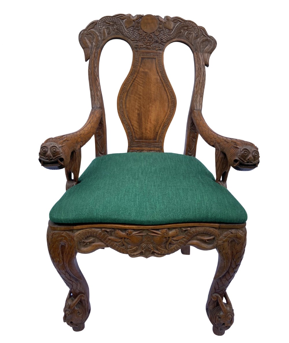 A pair of 19th-century carved teak Chinese armchairs featuring dragon motif armrests, detailed back splats, cabriole legs, and green upholstered seat cushions. View II