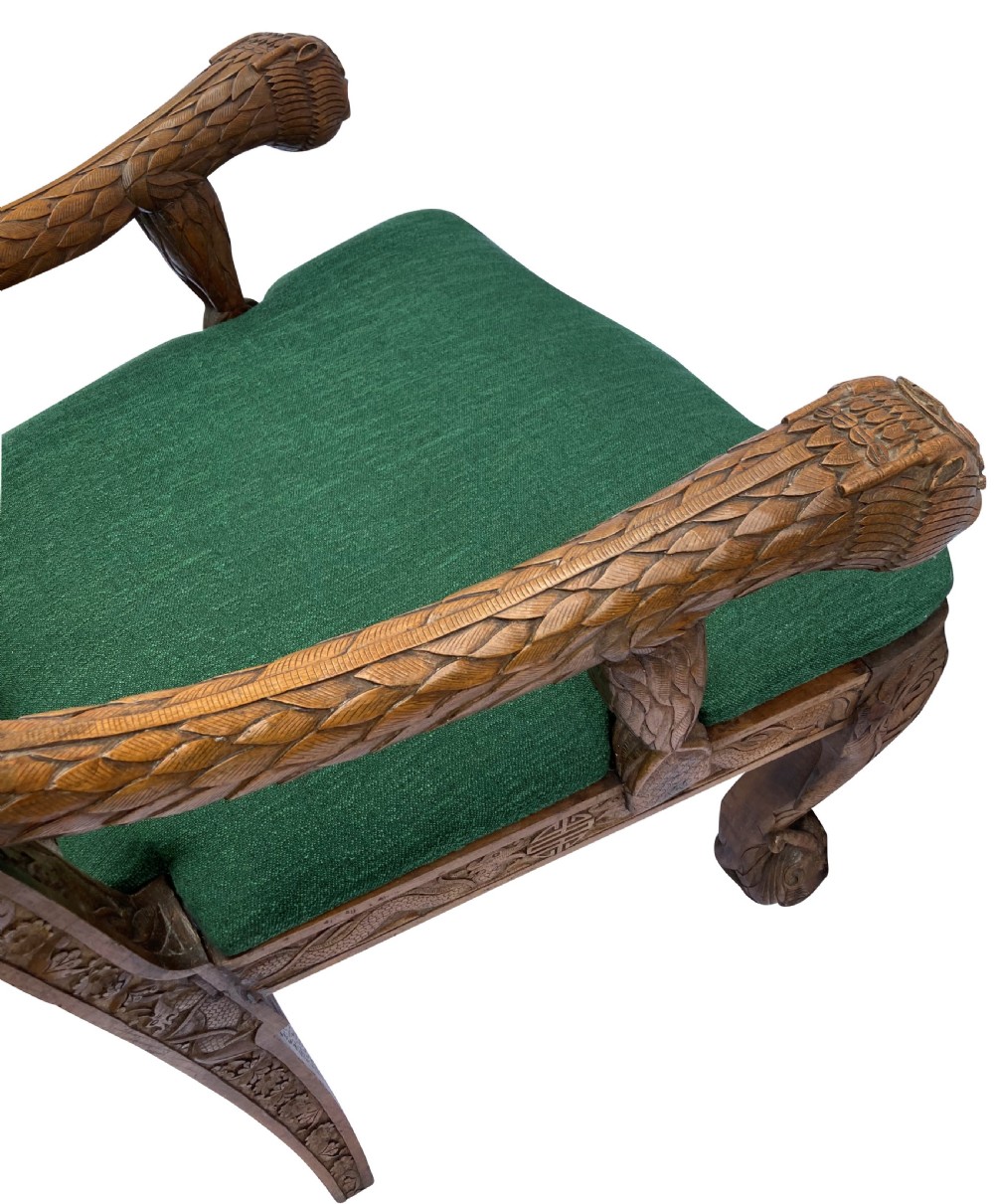 A pair of 19th-century carved teak Chinese armchairs featuring dragon motif armrests, detailed back splats, cabriole legs, and green upholstered seat cushions. View VIII
