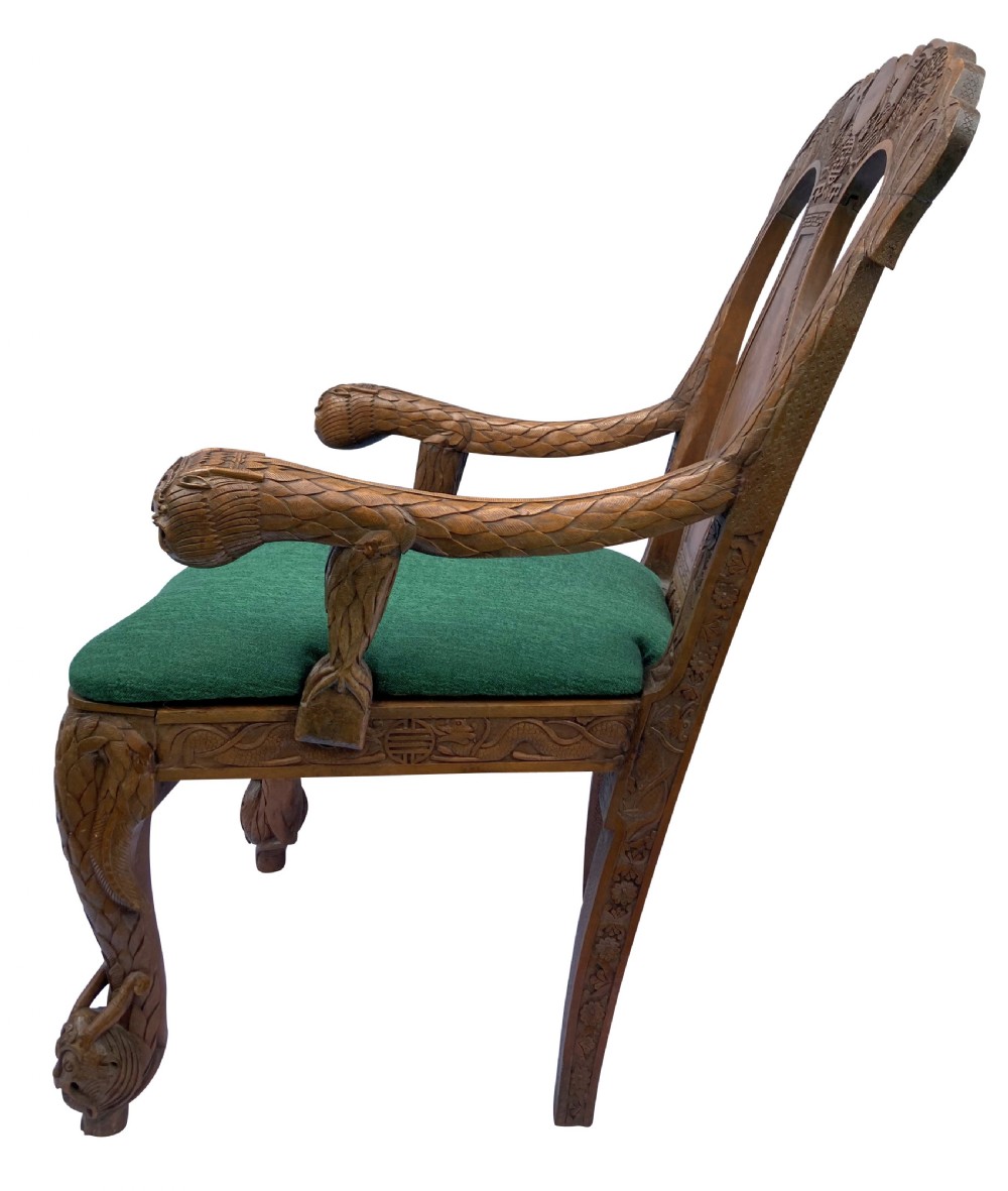 A pair of 19th-century carved teak Chinese armchairs featuring dragon motif armrests, detailed back splats, cabriole legs, and green upholstered seat cushions. View XI