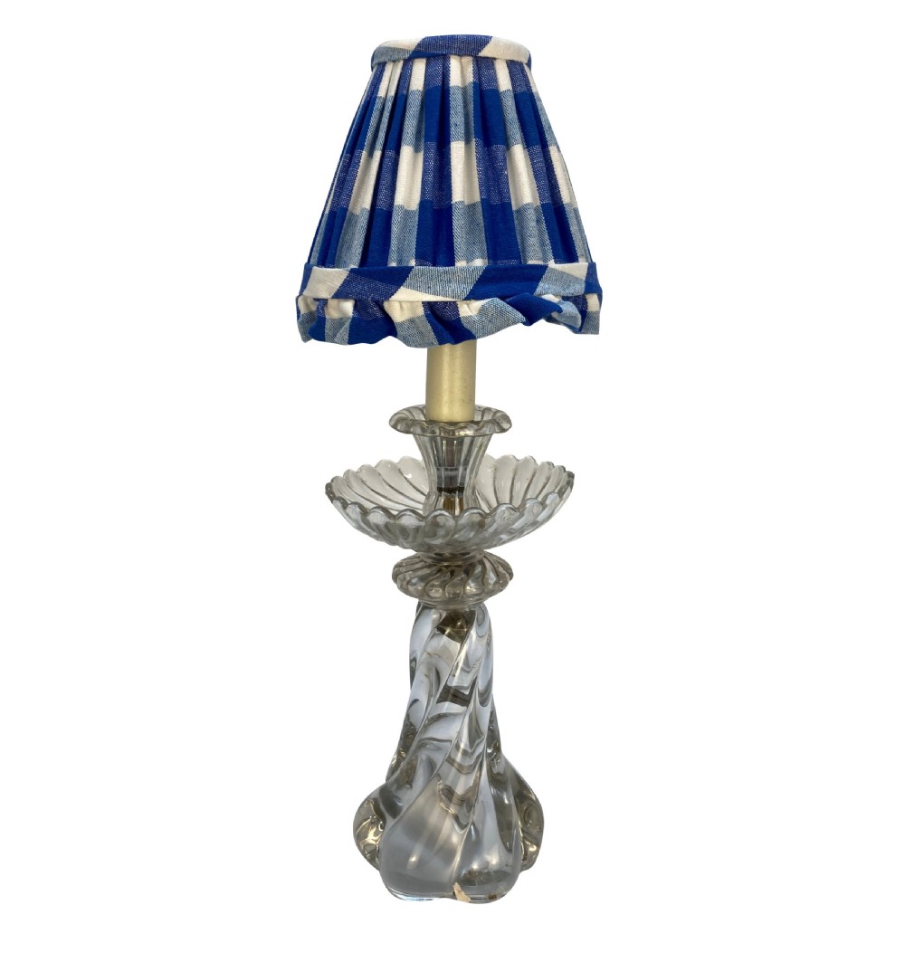 A 1930s French table lamp featuring a twisted moulded clear glass stem with a scalloped dish detail, topped with a blue and white gingham pleated lampshade.