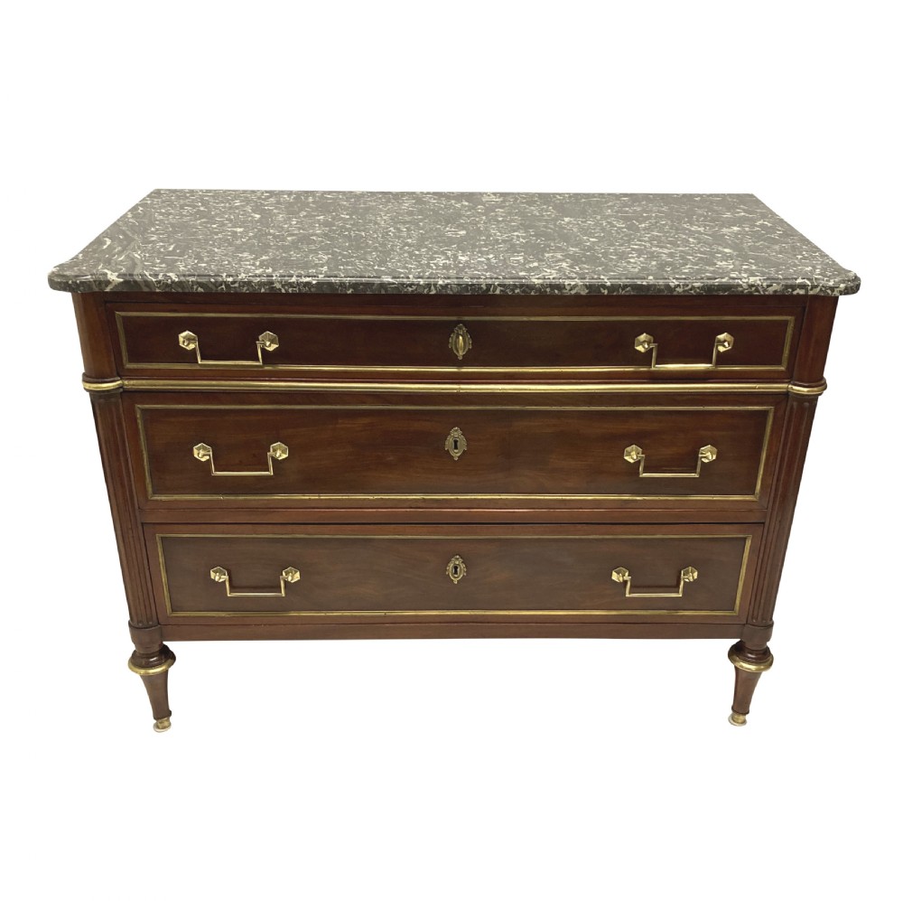 A French Directoire mahogany commode featuring three long drawers with brass mounts, fluted corner pilasters, and a grey marble top. View II