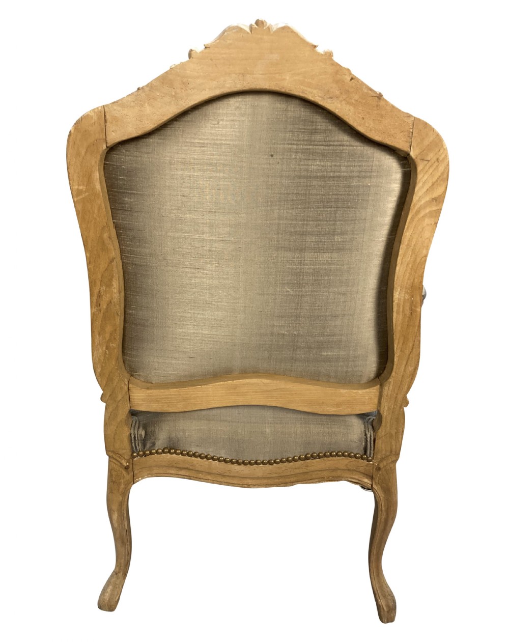 A Louis XV style armchair featuring a carved bleached fruitwood frame with cabriole legs and grey silk upholstery secured with brass studs. View VII