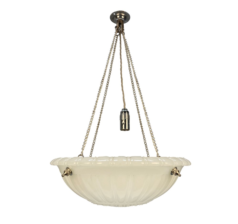 A translucent off-white carved alabaster dish ceiling light suspended by three brass link chains from a central ceiling rose.