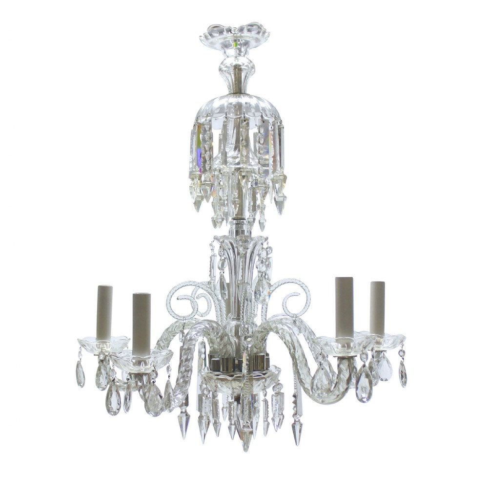 A small clear cut glass chandelier featuring curved glass arms, candle sockets, and faceted crystal drops.