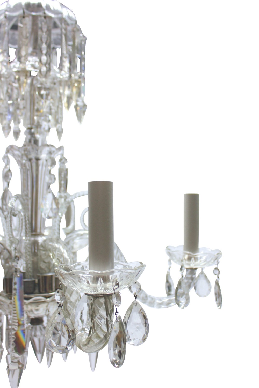 A small clear cut glass chandelier featuring curved glass arms, candle sockets, and faceted crystal drops. View V