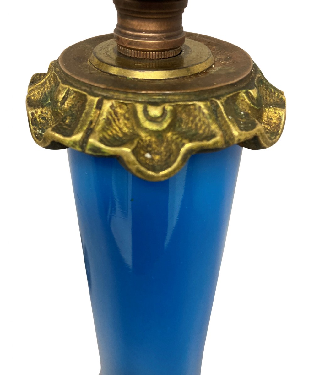 A late 19th-century French table lamp featuring a vibrant blue glass body mounted on a ornate gilt bronze scroll base. View III