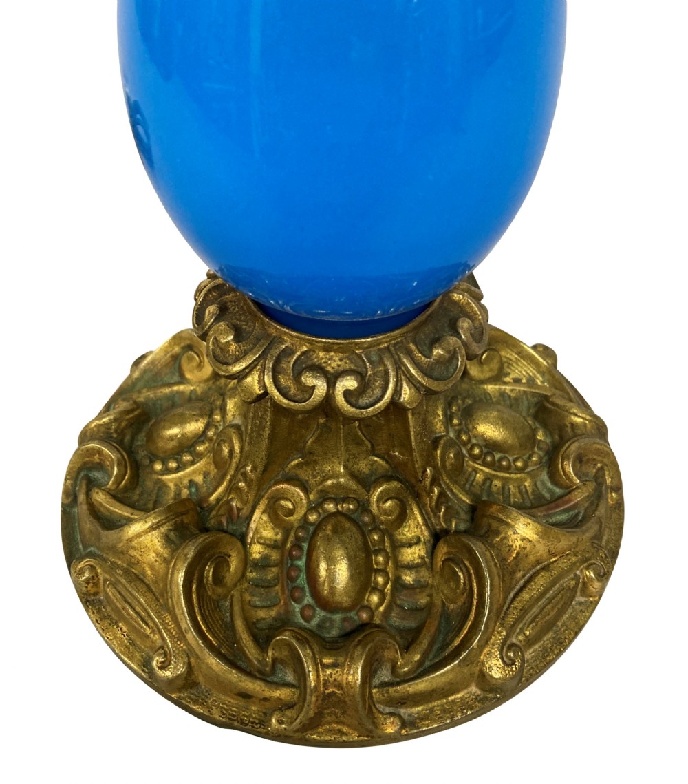 A late 19th-century French table lamp featuring a vibrant blue glass body mounted on a ornate gilt bronze scroll base. View IV