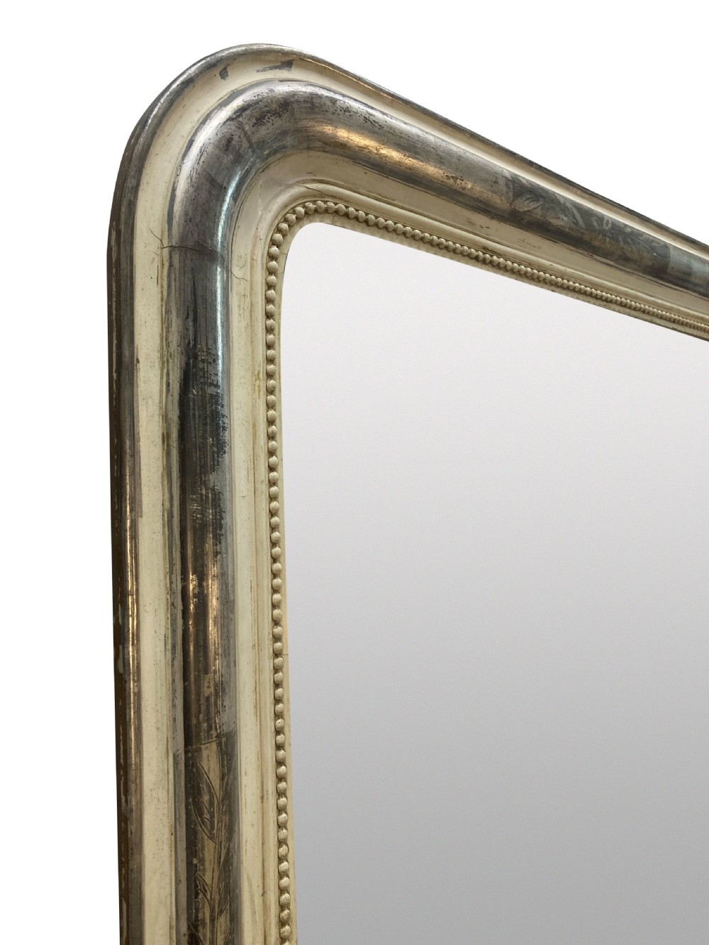 An antique French silver leaf overmantel mirror featuring rounded top corners, a beaded inner rim, and subtle etched leaf motifs on the frame. View III