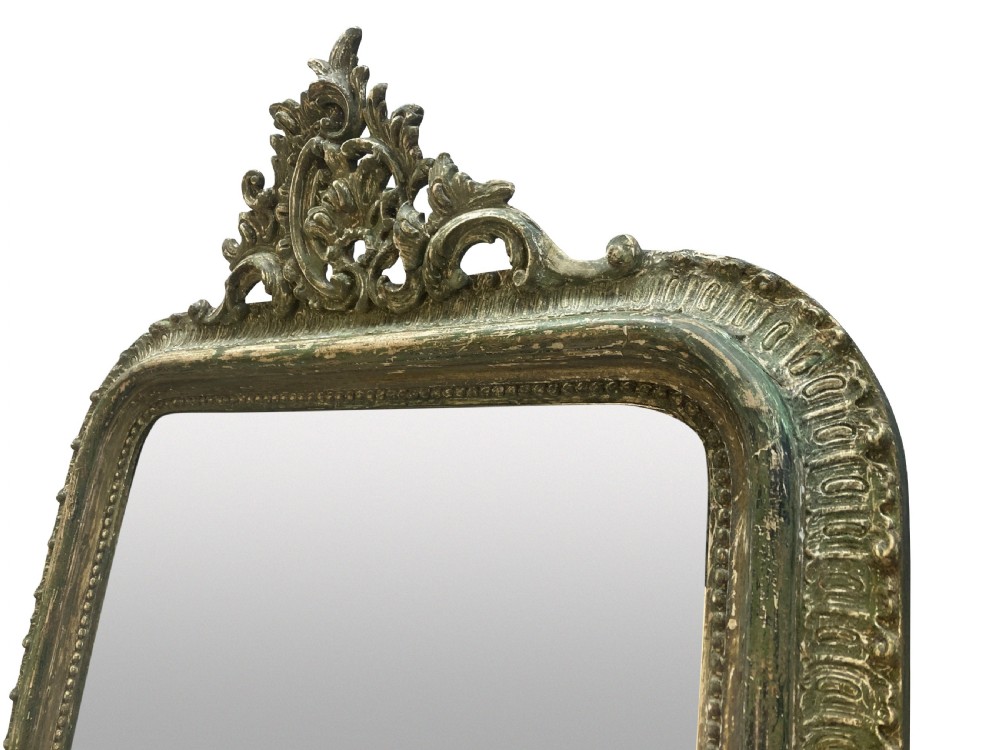 An arched Louis XV style rectangular overmantel mirror featuring a carved ornate scroll crest and a weathered green and gilded frame. View II